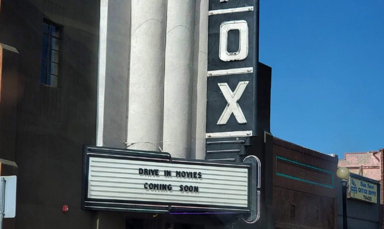 White large letters reading "Fox" of a theater marquee with small black text that reads "Drive In Movies Coming Soon"